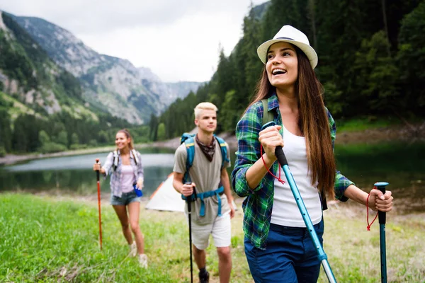 Friends hiking together outdoors exploring the wilderness and having fun