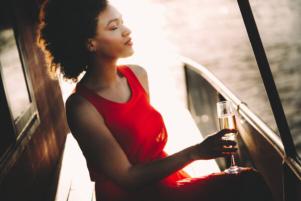 Fashion portrait of sexy pretty african woman with drink outdoor