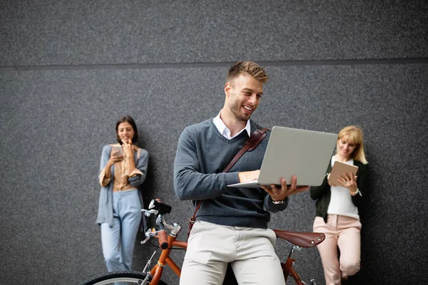 Living in digital age. Group of happy young people holding different digital devices outdoor. technology concept