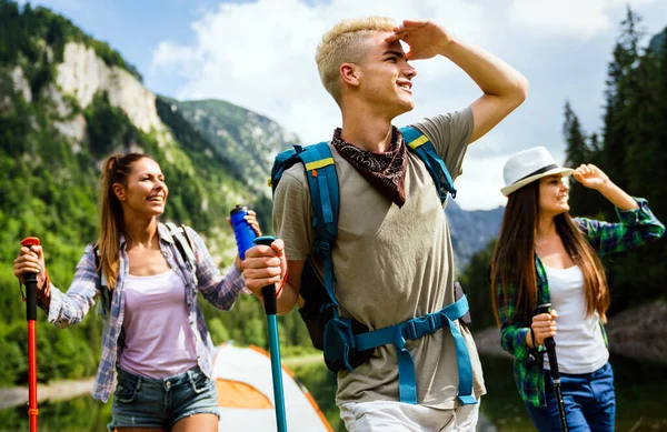 Happy hiker group of friends trekking as part of healthy lifestyle outdoors activity