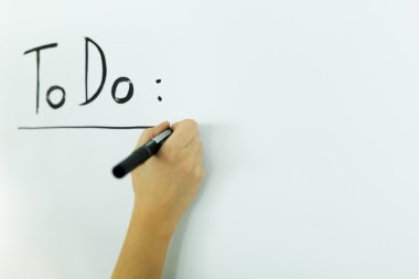 writing todo onto a writing board