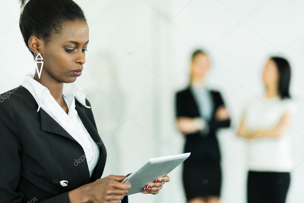 Businesswoman holding a tablet and concentrating on the contents
