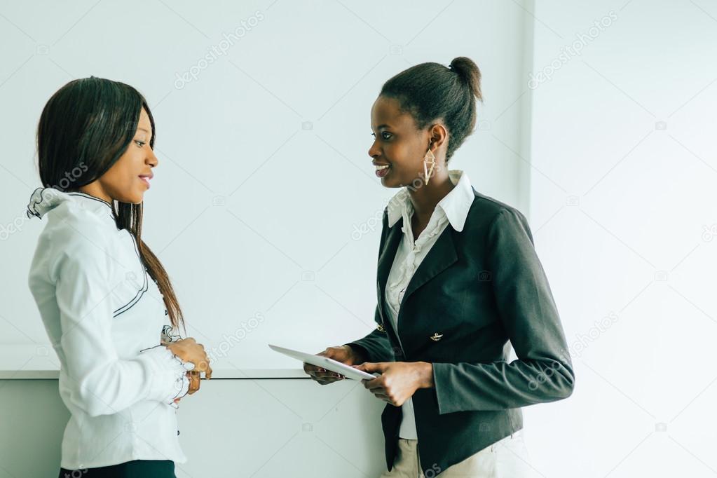 Two colleagues talking about the contents on a tablet pc