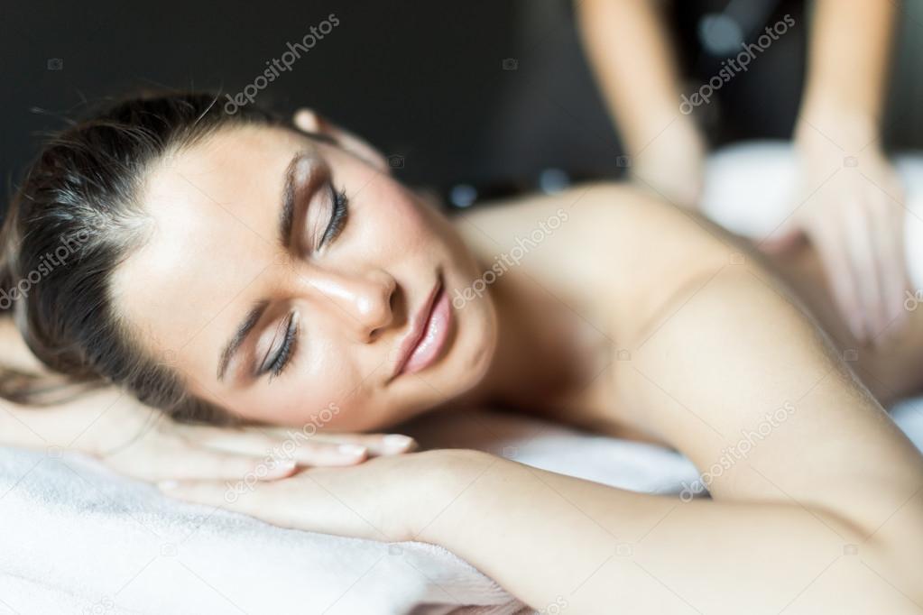 Woman being massaged with hot stones