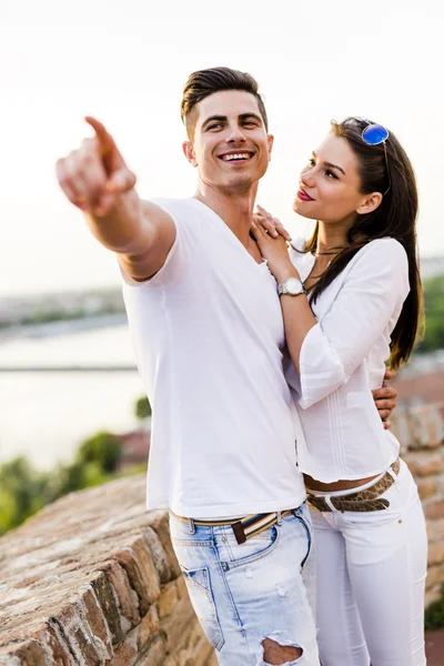 Happy couple pointing in a direction — Stock Photo, Image