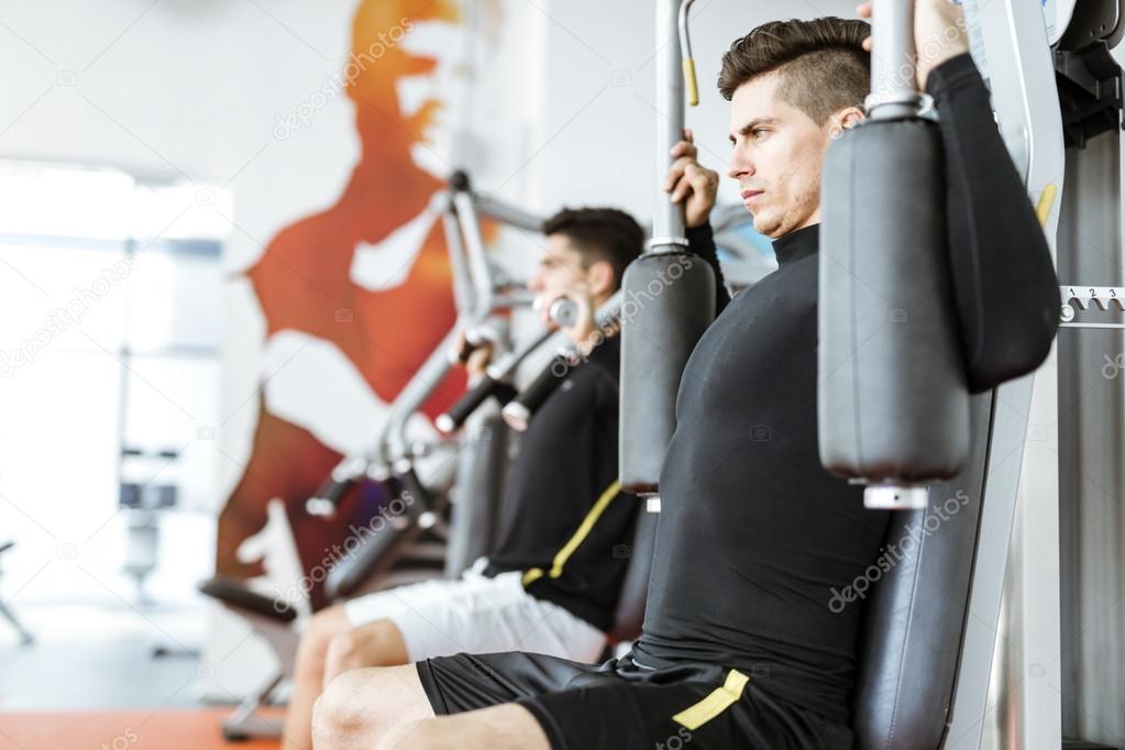Handsome men working out in a  gym