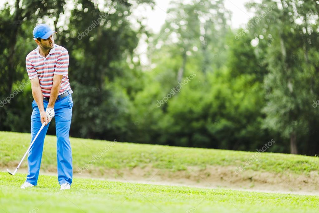 Golfer practicing and concentrating before and after shot during a nice sunny day