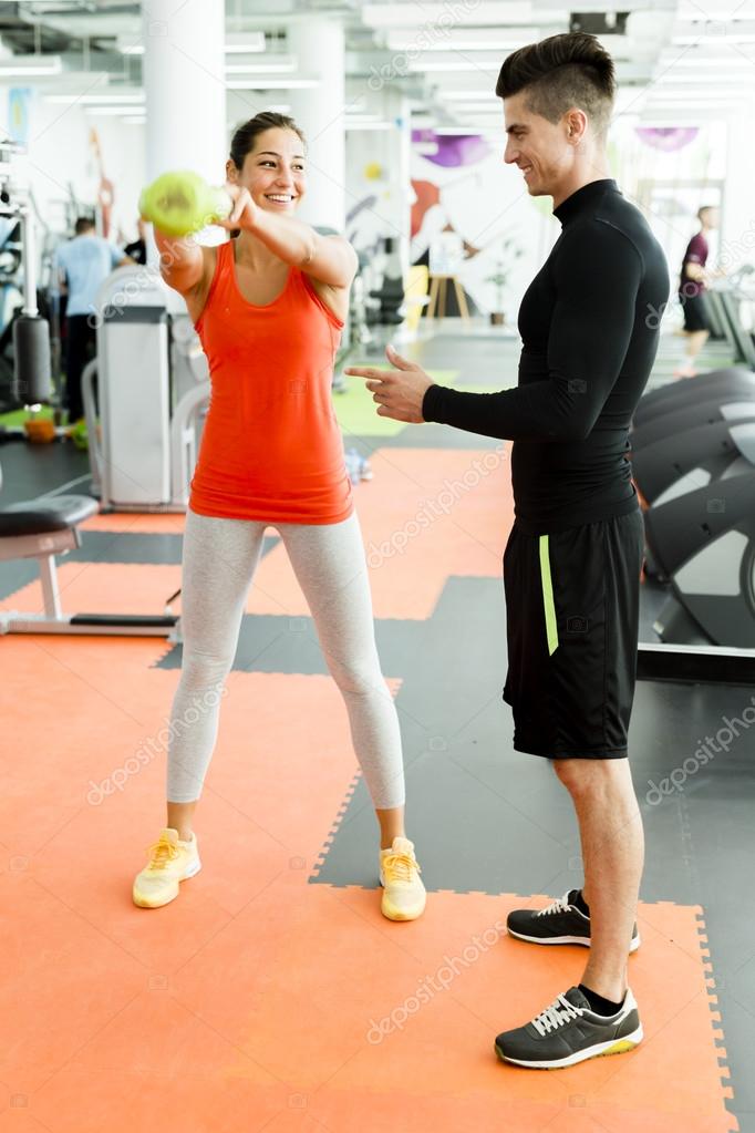 Male trainer giving instructions to a woman