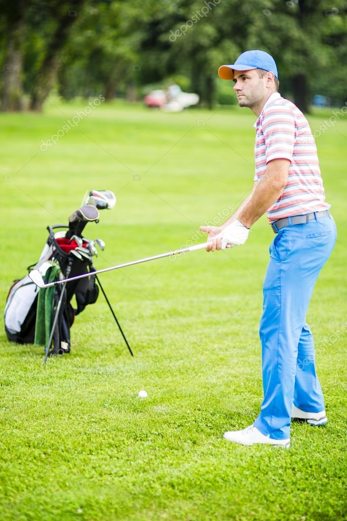 Golfer practicing and concentrating before and after shot during a nice sunny day