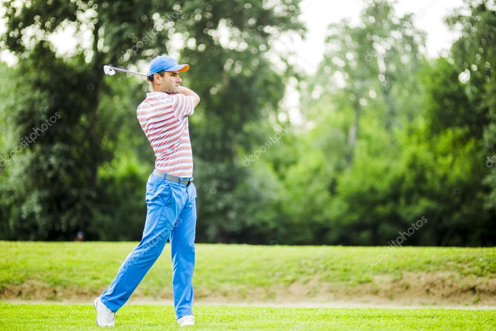 Golfer practicing and concentrating before and after shot during a nice sunny day