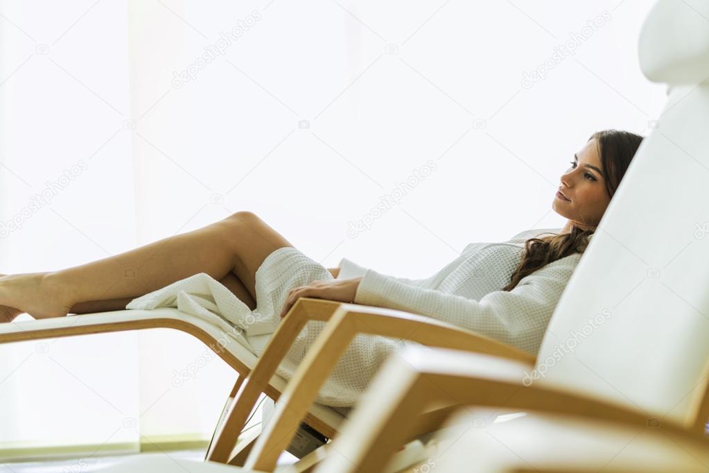 Woman relaxing in a chair dressed in a robe