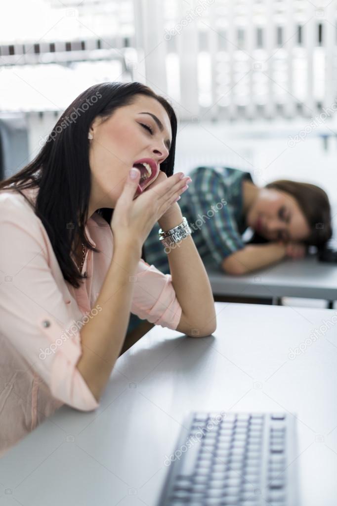 Beautiful girl yawning during class