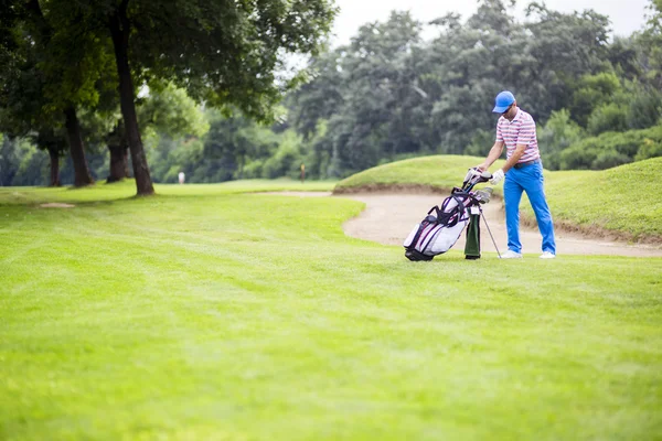 Golfspelare att välja ut lämpliga club — Stockfoto