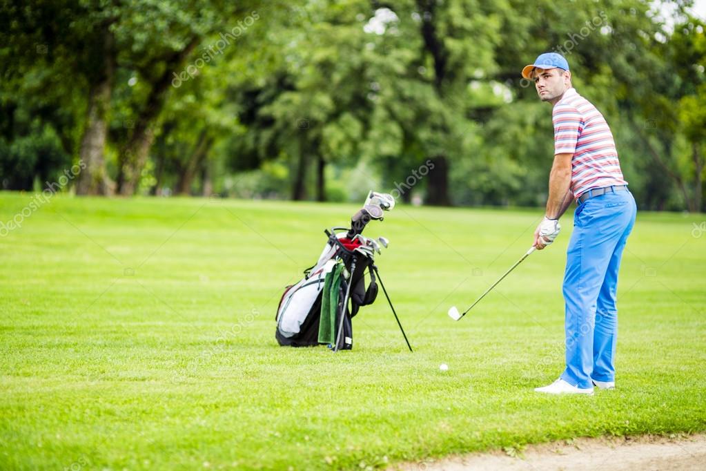 Golfer practicing and concentrating before and after shot during a nice sunny day