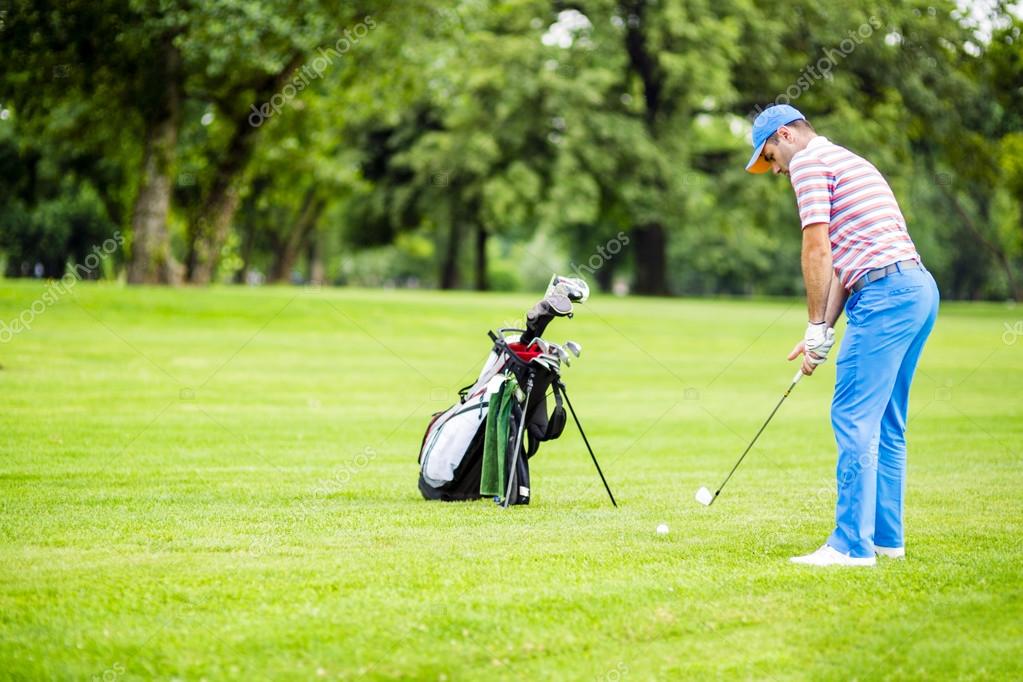 Golfer practicing and concentrating before and after shot during a nice sunny day