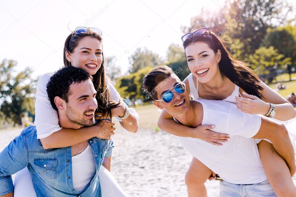 Happy people carrying women on a beach