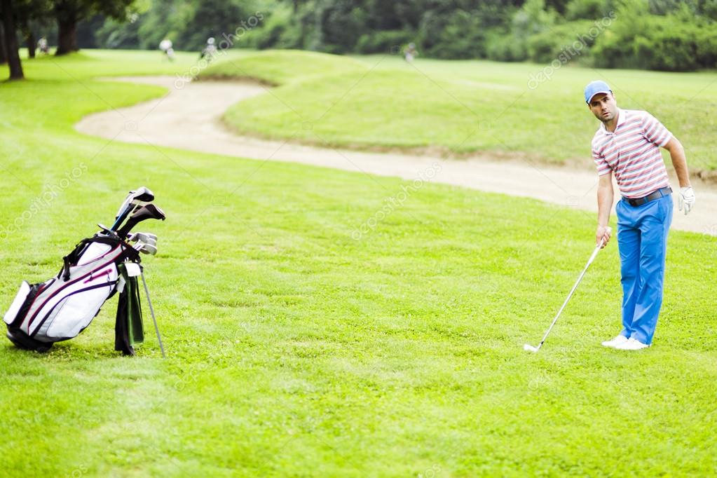 Golfer practicing and concentrating before and after shot during a nice sunny day