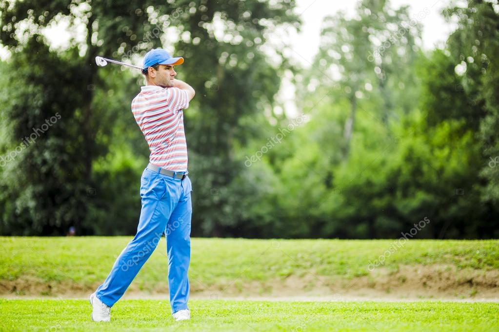 Golfer practicing and concentrating before and after shot during a nice sunny day