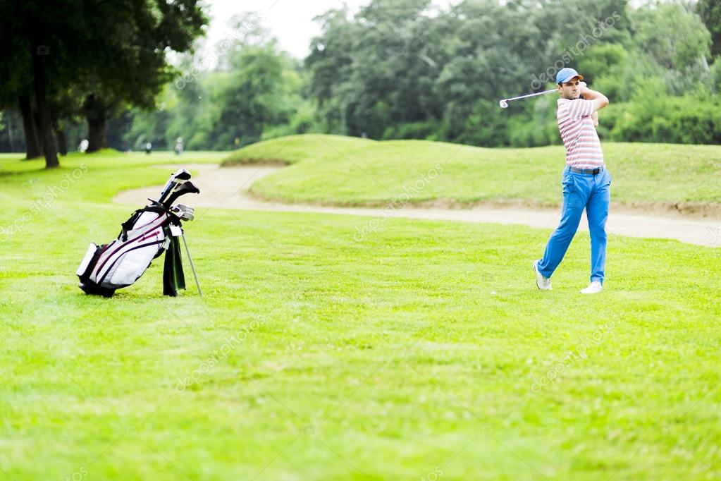 Golfer practicing and concentrating before and after shot during a nice sunny day