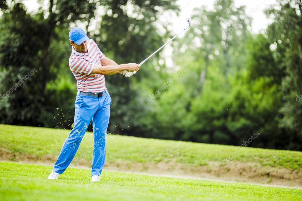Golfer practicing and concentrating before and after shot during a nice sunny day