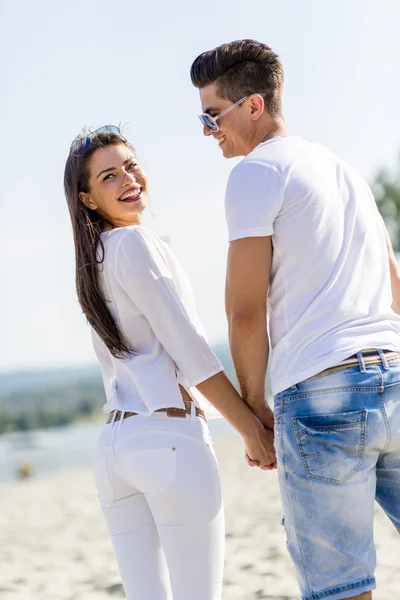 Couple holding hands on a beach — Stock Photo, Image