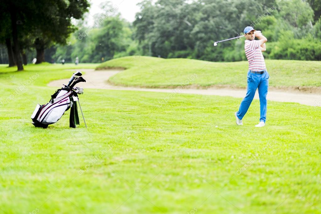 Golfer practicing and concentrating before and after shot during a nice sunny day