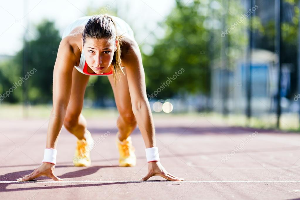Female sprinter getting ready for the run