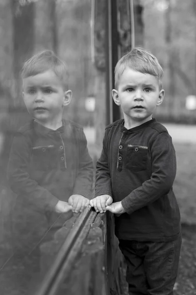 Little boy with reflection on glass — Stock Photo, Image