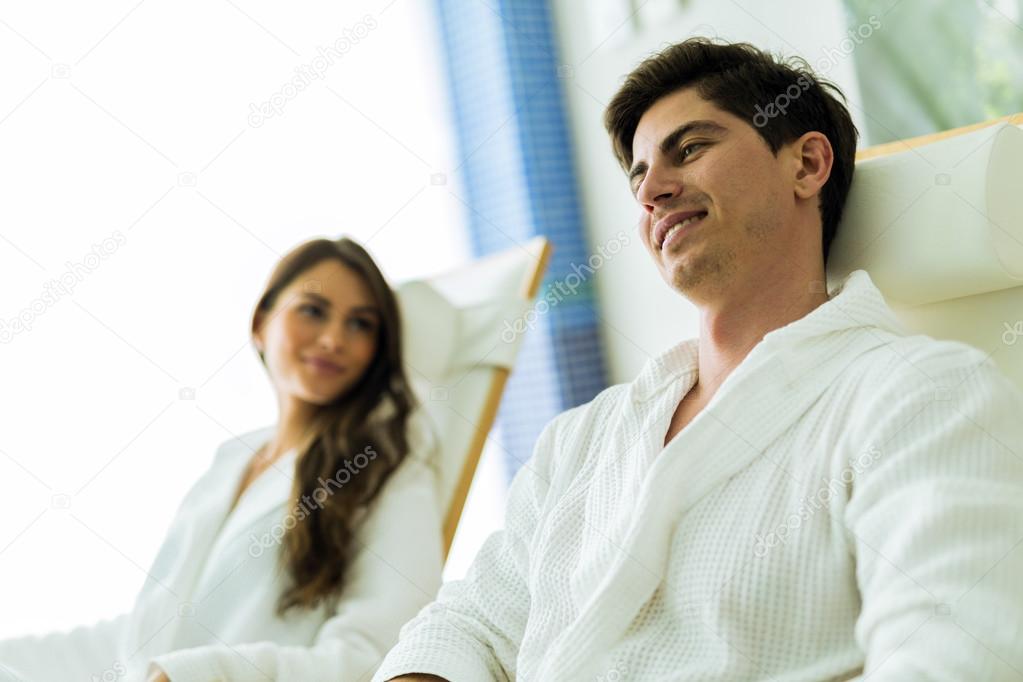 A handsome man relaxing in a chair at a spa