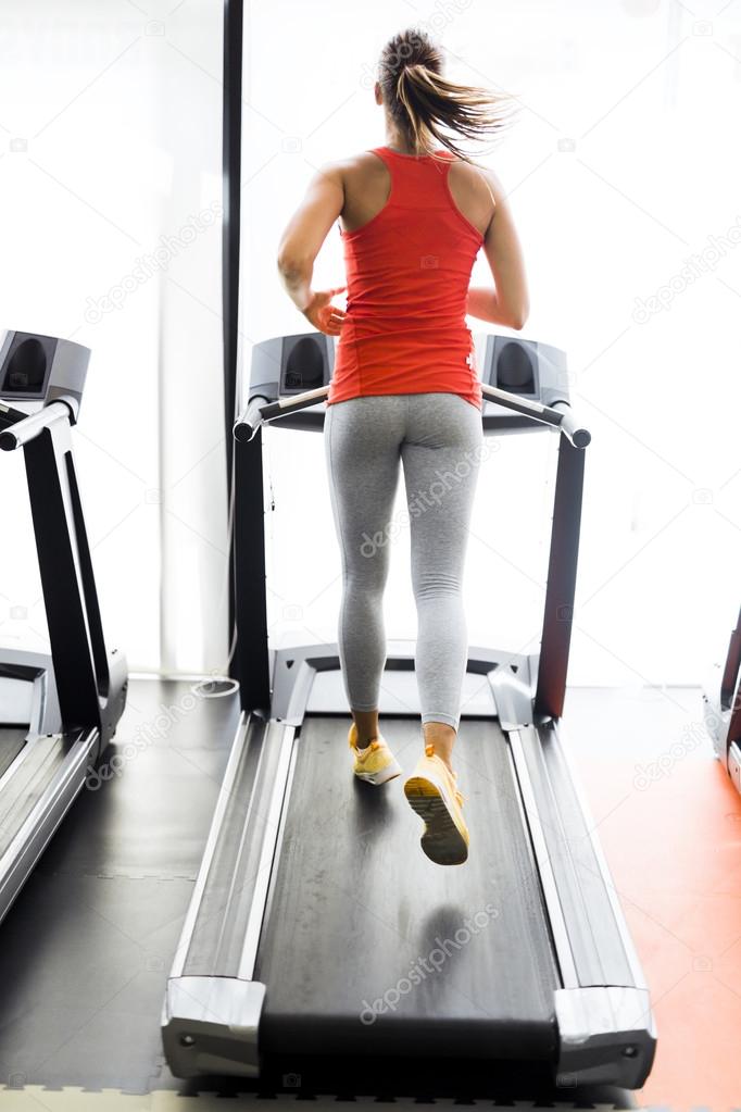 Woman running on a treadmill in gym