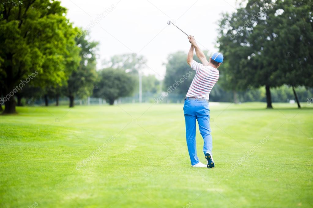 Golfer practicing and concentrating before and after shot during a nice sunny day