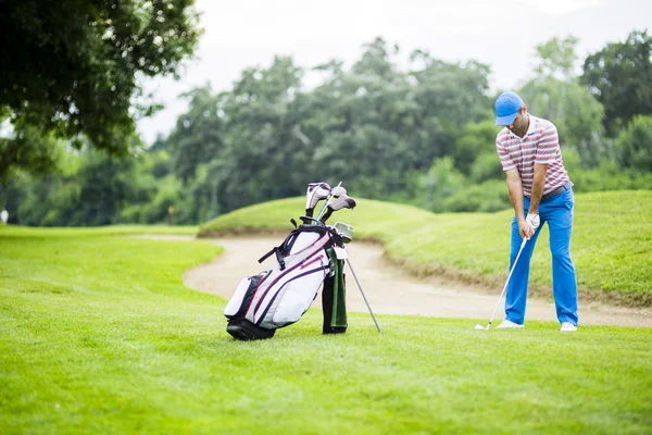 Golfer practicing before and after shot — Stock Photo, Image