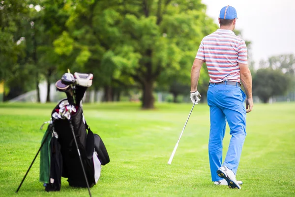 Golfer practicing before and after shot — Stock Photo, Image