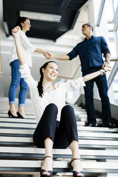 Business people shaking hands on stairs — Stock Photo, Image