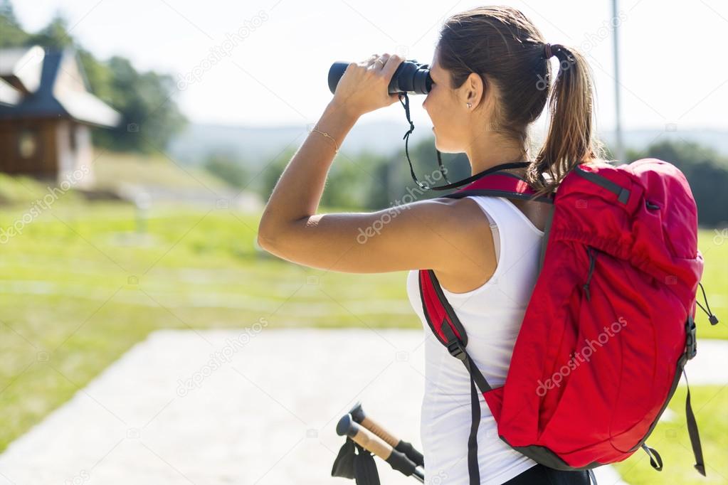 Tourist hiking and using binoculars