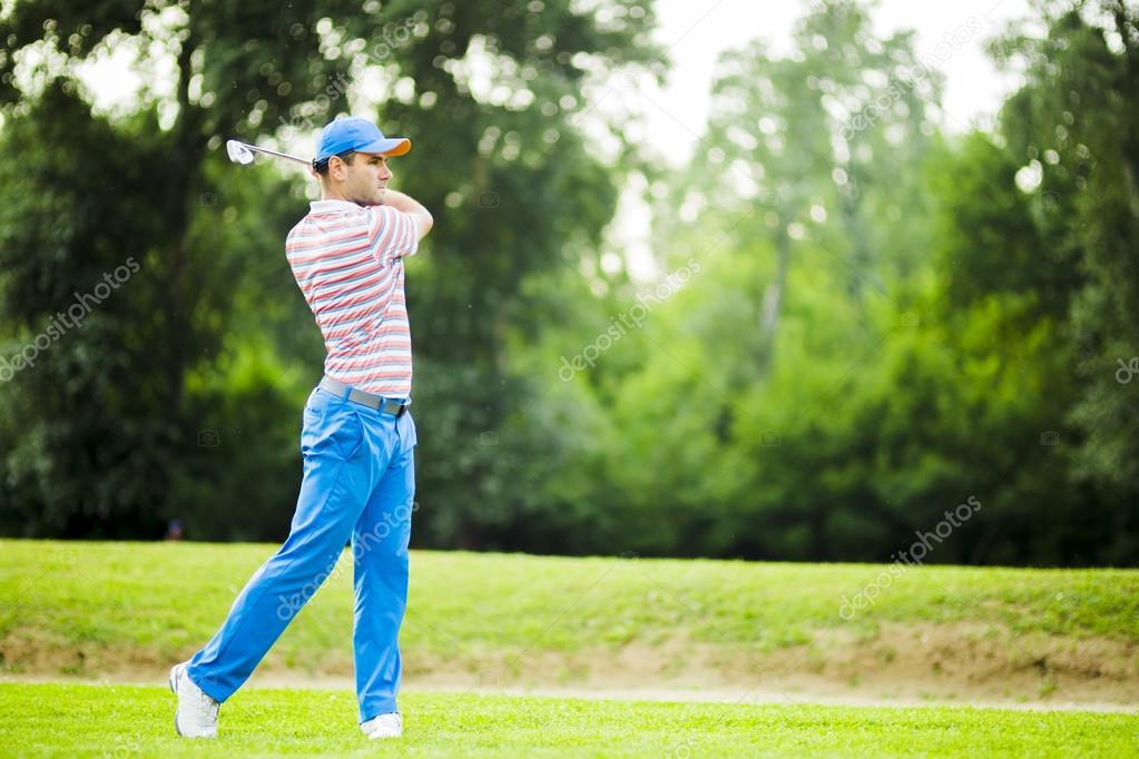 Golfer practicing and concentrating before and after shot during a nice sunny day