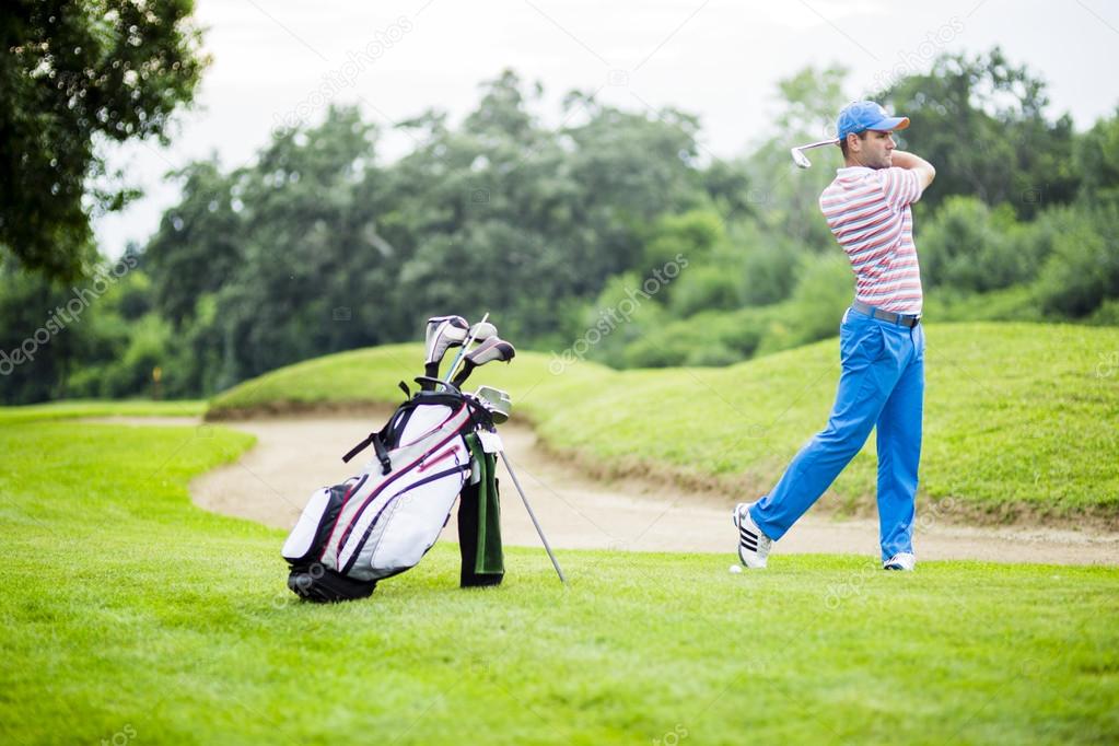 Golfer practicing and concentrating before and after shot during a nice sunny day