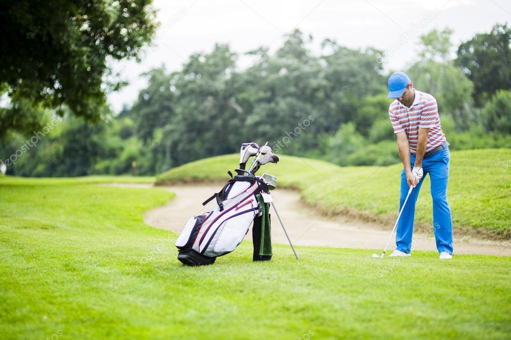 Golfer practicing and concentrating before and after shot during a nice sunny day