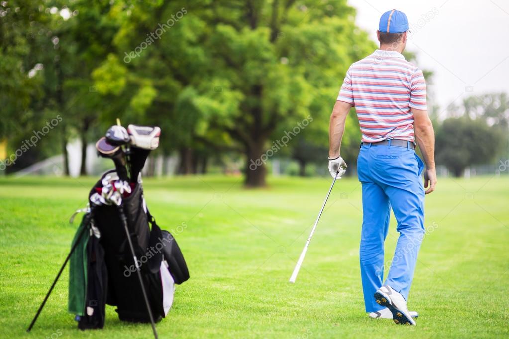 Golfer practicing and concentrating before and after shot during a nice sunny day