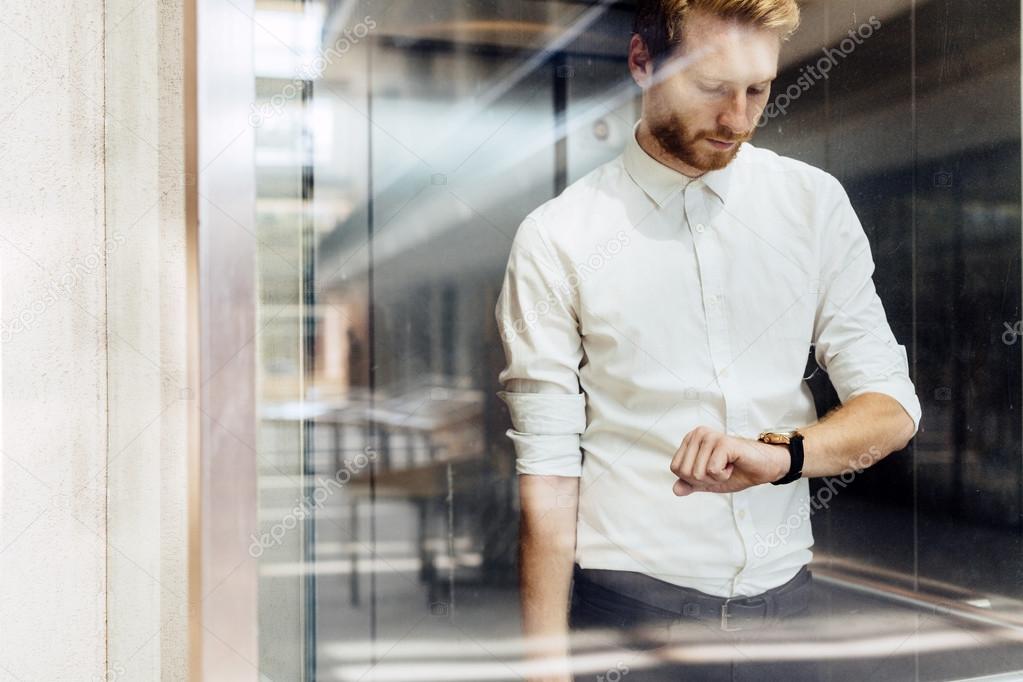 Businessman checking watch