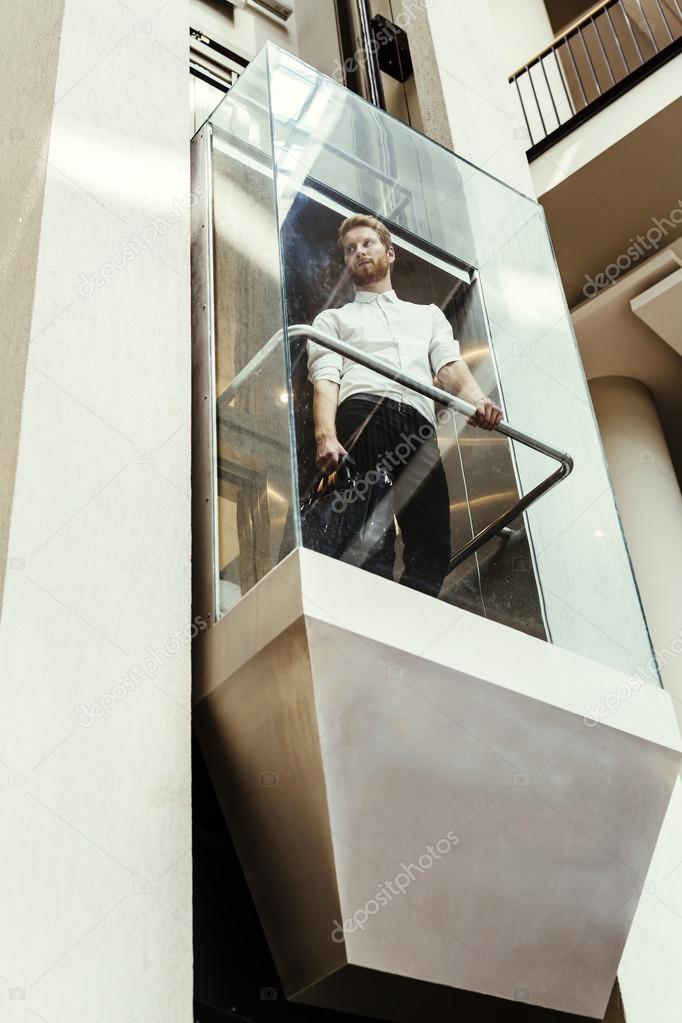 Businessman taking the elevator