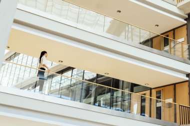 Şık iş kadını binanın içinde yürüyüş