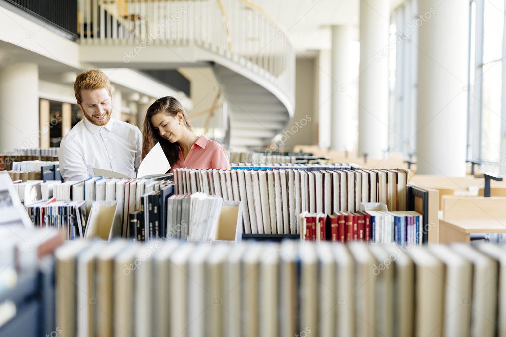 Two students reading and studying in library