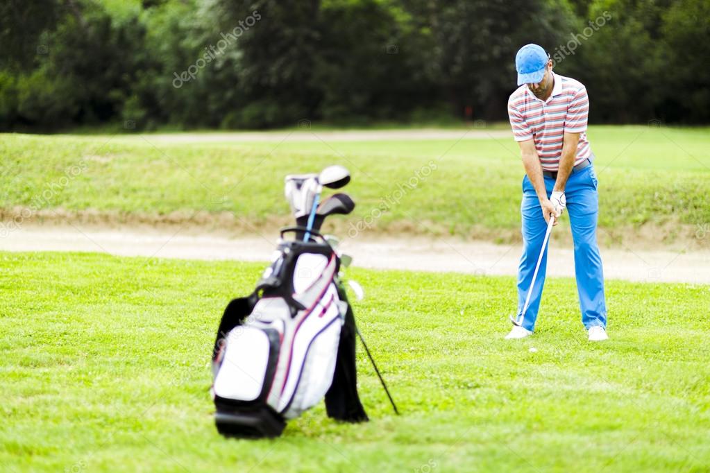 Golfer practicing and concentrating before and after shot during a nice sunny day