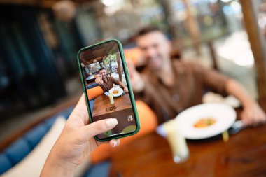 restaurant marketing with user generated content: a diverse couple creates social proof as content drives reviews, bookings, loyalty and growth