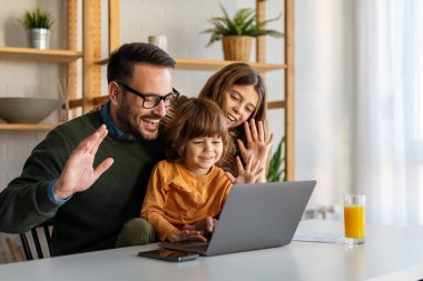 Happy single father with kids having fun online with application, watching video cartoons or playing game on laptop together