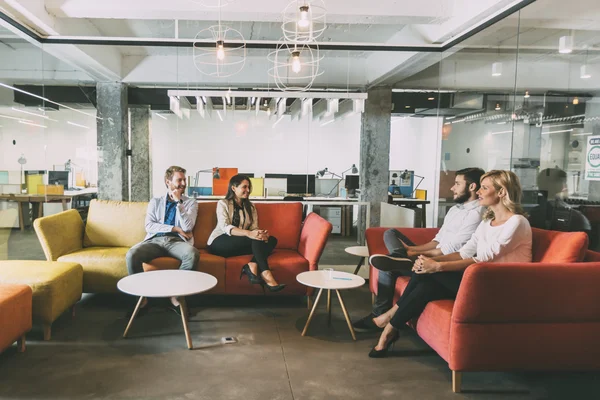 Group of people talking in modern cafe — Stock Photo, Image