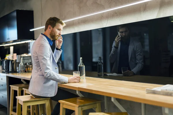 Homem de negócios bebendo e usando telefone — Fotografia de Stock