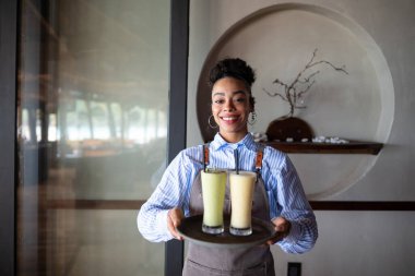 Thriving restaurant business, young entrepreneur creating a successful dining experience with exceptional service, quality drinks, and customer satisfaction