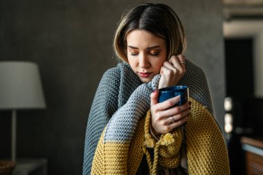 Pencerenin kenarında sakin bir sabah kahvesi anı, sakin rutinleri, samimi duyguları ve sıcak bir içkinin rahatlatıcı ritüelini temsil ediyor.